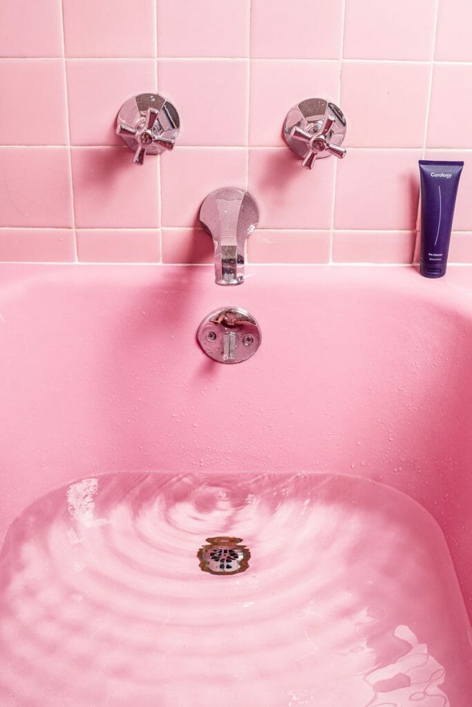 pink bathroom tile and tub