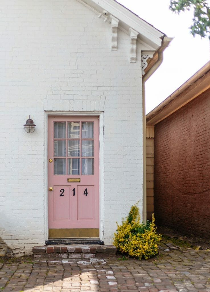 pink front door on white house