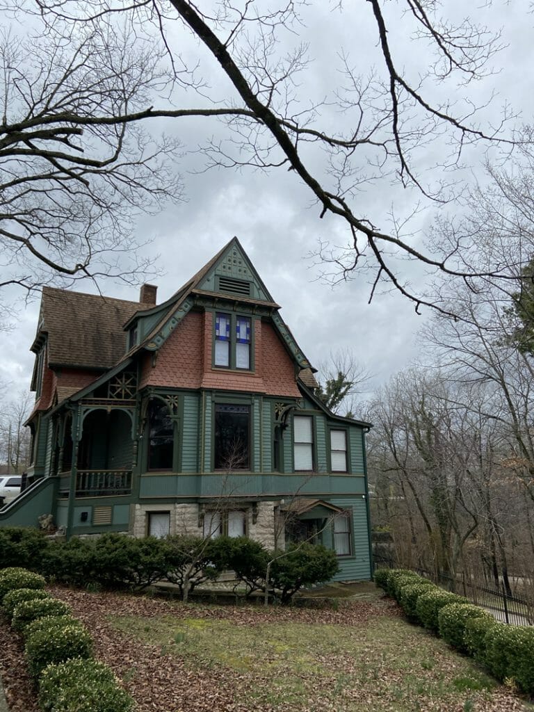 an painted lady or Victorian home with different color and textures of siding